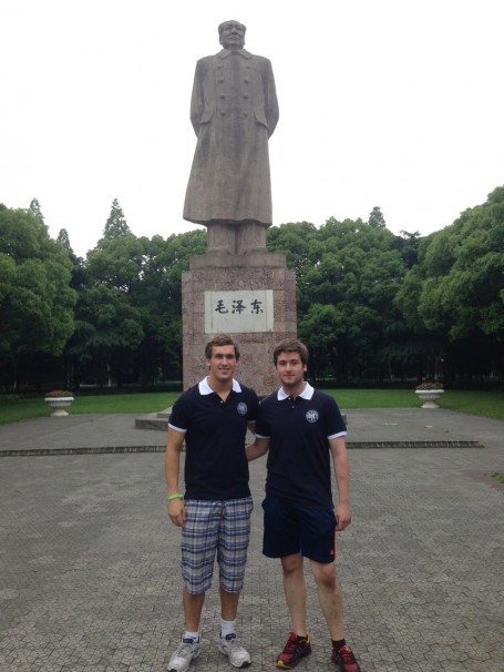 Joshua Neill and JJ Bassette standing in front of the Mao Zedong Statue 