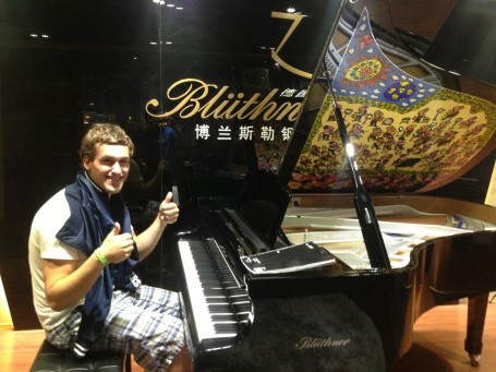 JJ Bassette at a piano store in Shanghai